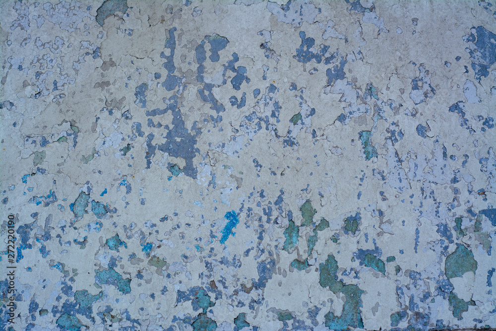 Old concrete wall with a complex texture of aged coating in shades of blue