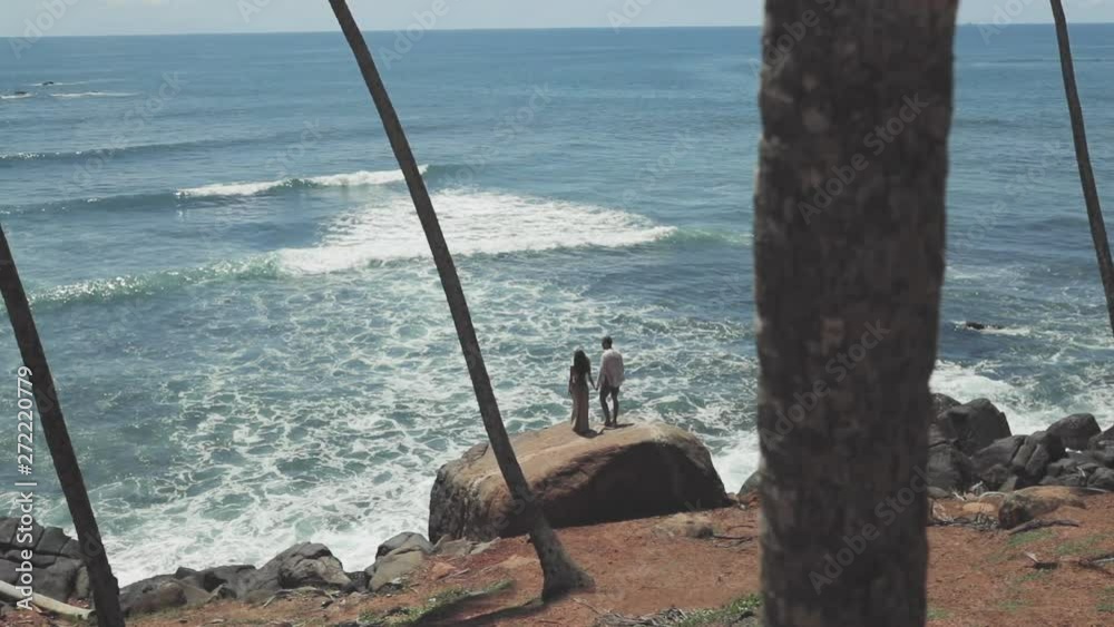 Couple standing on cliff