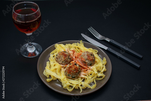 Pasta with meatballs on a dark background