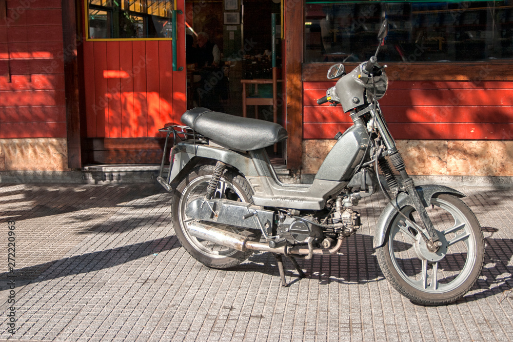 an old motorbike stands at a motor show.