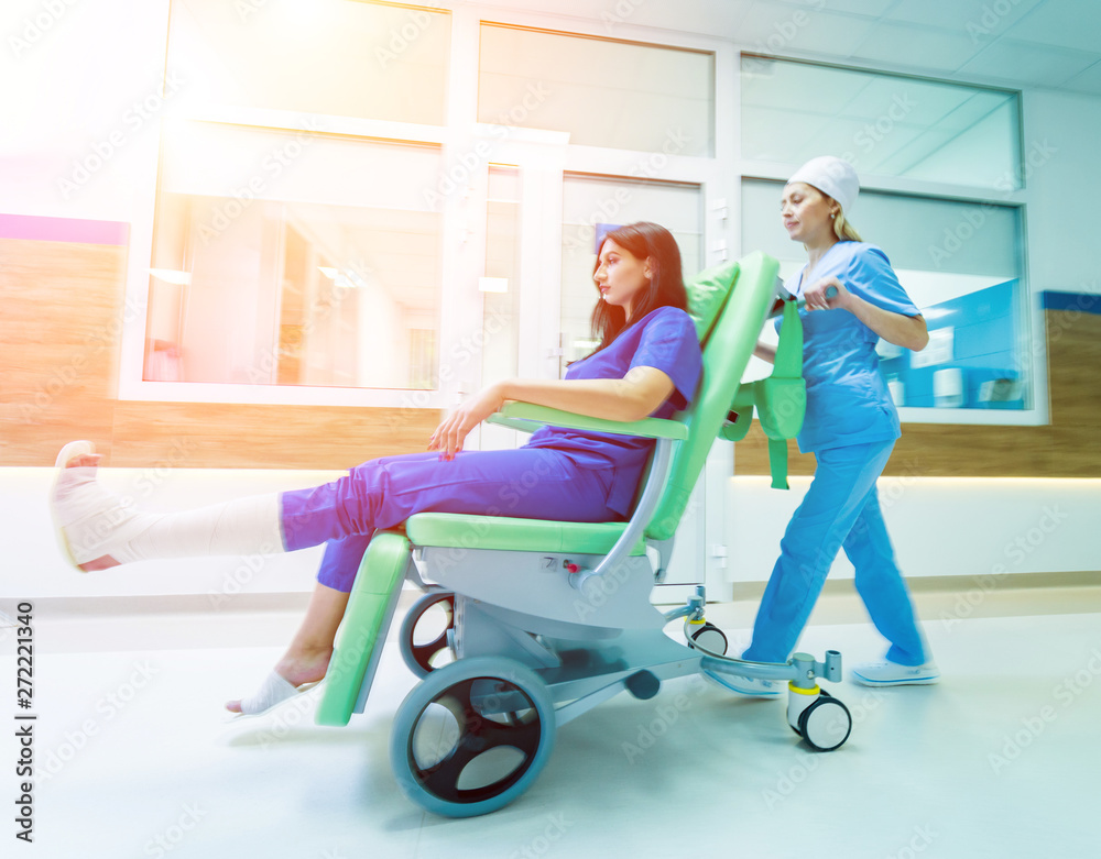 Nurse moves mobile medical chair with patient at hospital. Medical equipment. Nurse moves mobile medical chair with patient at hospital. Medical equipment.