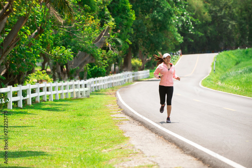 Asia sporty woman runner running in park, female in sport cloth jogging at park,healthy sport active lifestyle concept © Tawan