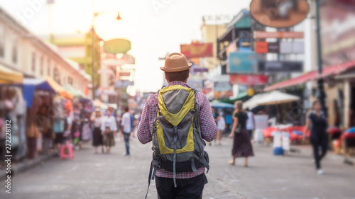 Young asian traveller man walking in Khaosan Road walking street in bangkok thailand on vacation time. © Nopphon