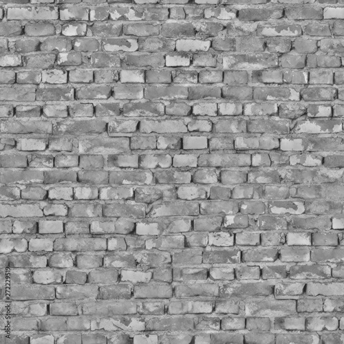 The damaged wall of the old building is made of dark gray bricks .Texture or background