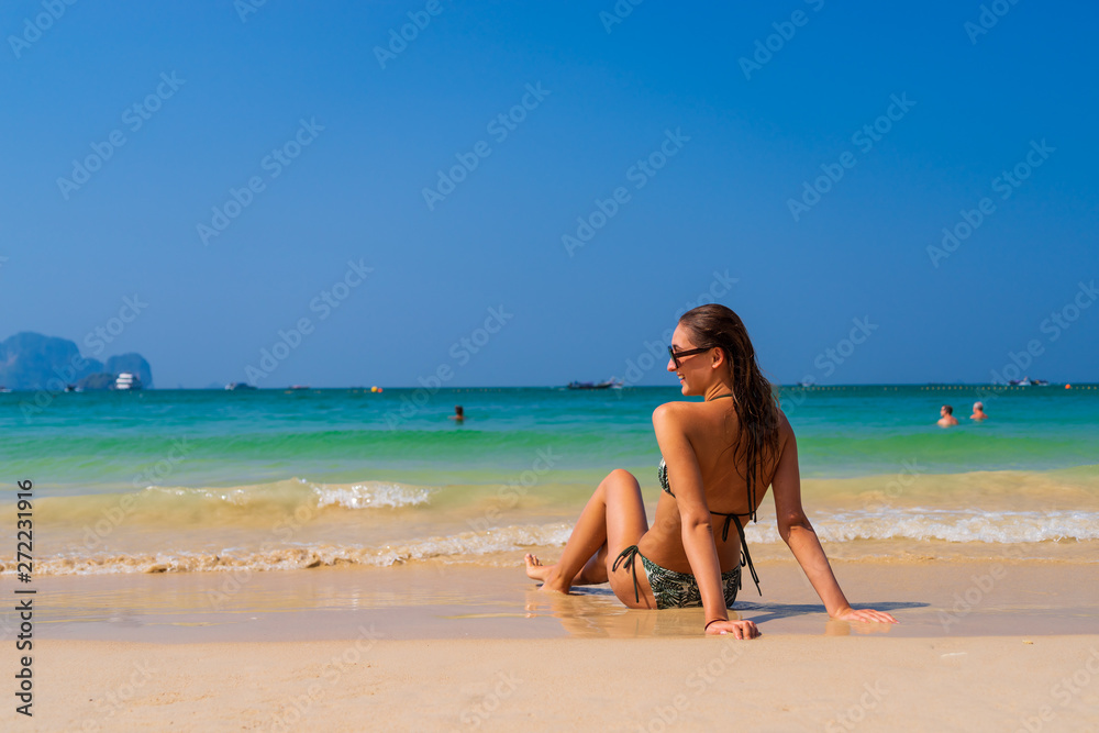 Cute woman relaxing on the summer beach.
