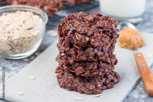 Flourless no bake peanut butter and oatmeal chocolate cookies  with glass of milk, horizontal photo