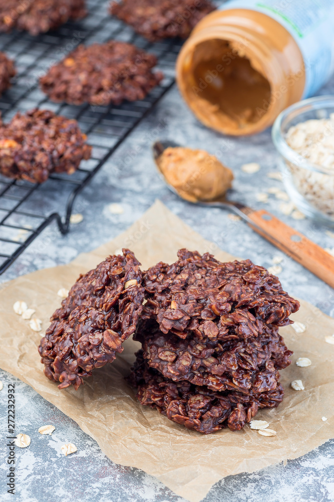 Flourless no bake peanut butter and oatmeal chocolate cookies on a parchment, vertical Flourless no bake peanut butter and oatmeal chocolate cookies on a parchment, vertical