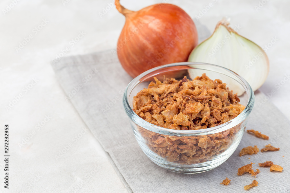 Fried onion in glass, topping for hot dog, fast food, horizontal, copy space Fried onion in glass, topping for hot dog, fast food, horizontal, copy space