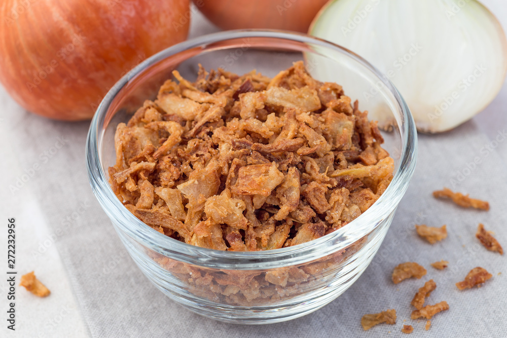 Fried onion in glass, topping for hot dog, fast food, horizontal, closeup Fried onion in glass, topping for hot dog, fast food, horizontal, closeup