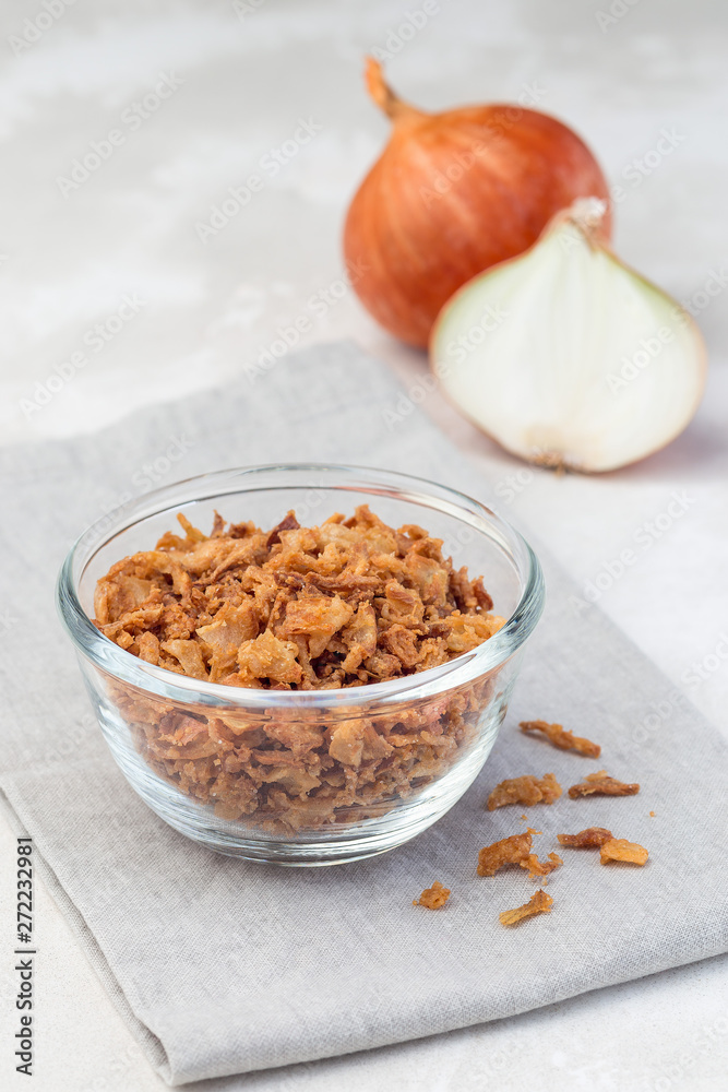 Fototapeta premium Fried onion in glass, topping for hot dog, fast food, vertical