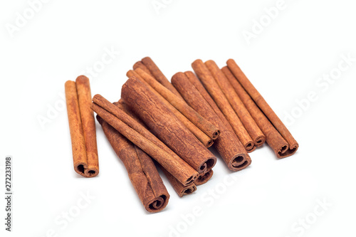 Heap of cinnamon sticks isolated on white