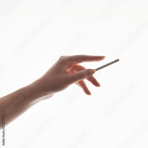 Woman holds a cigarette in her hand. Bad habits. Smoking is harmful to health.