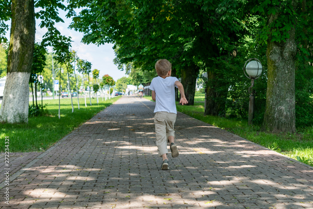 Fototapeta premium Portrait of a boy walking in the Park