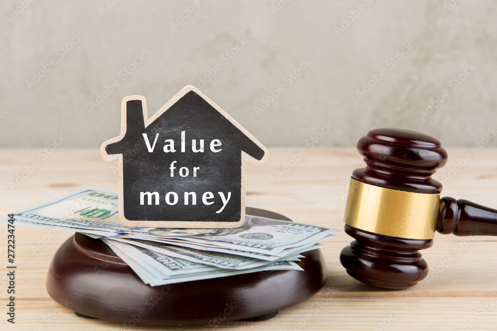 Real estate concept auction gavel and little house with inscription Value for money