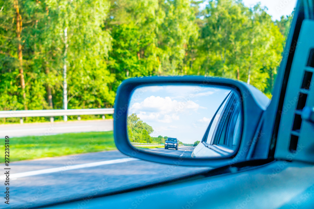 View of the road in the rear view mirror