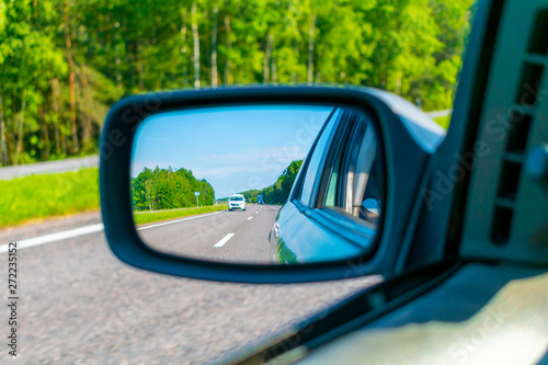 View of the road in the rear view mirror
