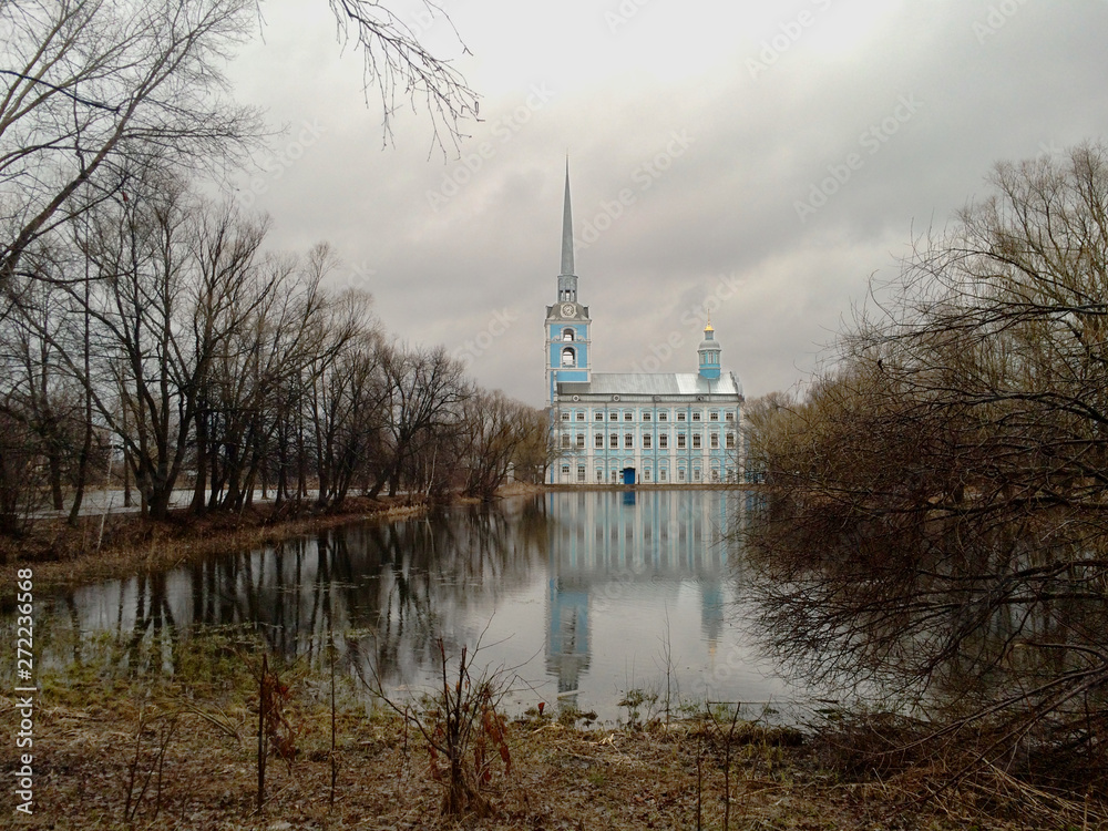 View of the park and the 18th century Orthodox Church Saint Peter and Saint Paul Cathedral in the Petrine Baroque architecture style in cloudy weather, Yaroslavl Russia