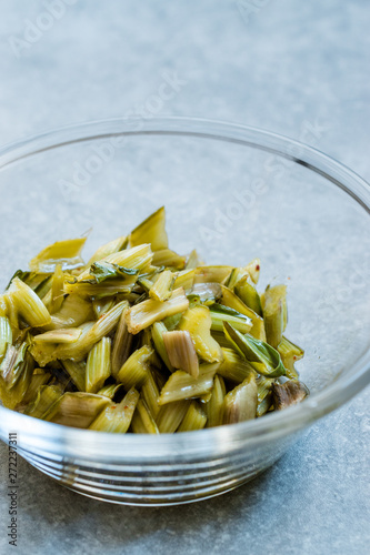 Marinated Chard Root Pickles Cut Diagonal in Glass Bowl.