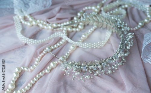 Wedding background with pearls and hair accessories on pink background