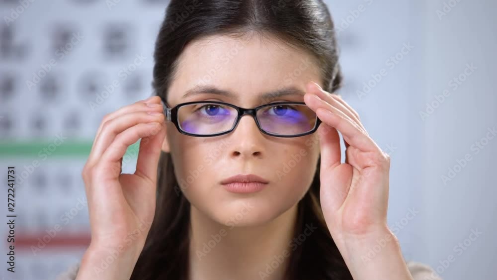 Upset lady trying new eyeglasses and taking them off, depressed with poor vision Upset lady trying new eyeglasses and taking them off, depressed with poor vision