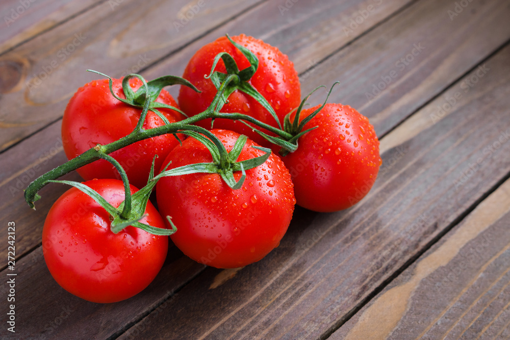 ripe tomatoes branch on wooden table ripe tomatoes branch on wooden table