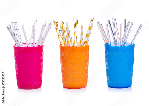 Cocktail tubes colorful in cup glass on white background isolation