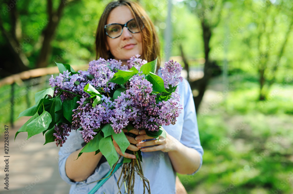 Beautiful young woman with bouquet of lilac Beautiful young woman with bouquet of lilac