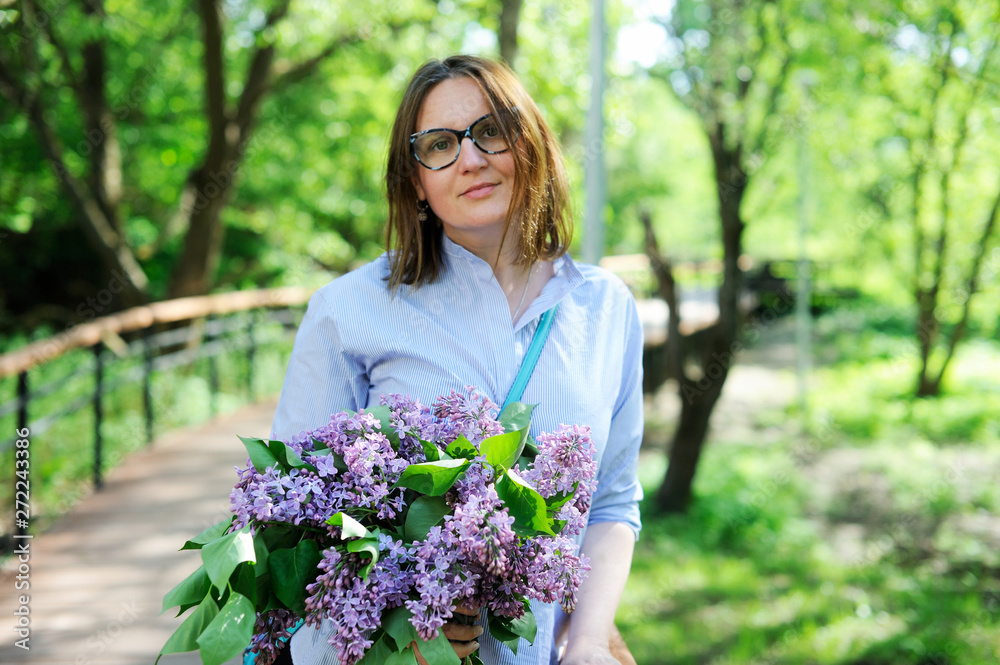 Beautiful young woman with bouquet of lilac Beautiful young woman with bouquet of lilac