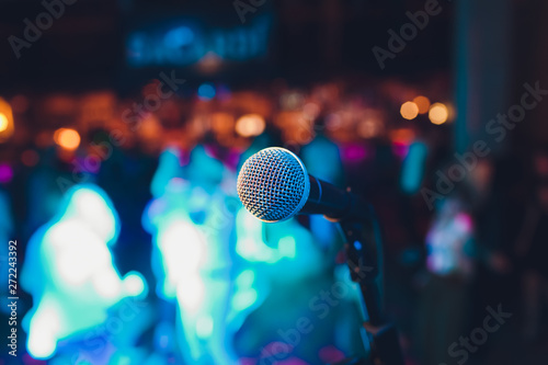 microphone on a stand up comedy stage with colorful bokeh , high contrast image. photo