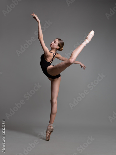 Fototapeta Beautiful flexible ballerina dancing in studio