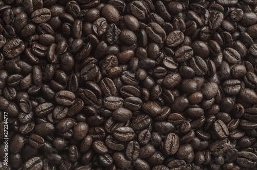 Roasted black coffee beans background. Top view.