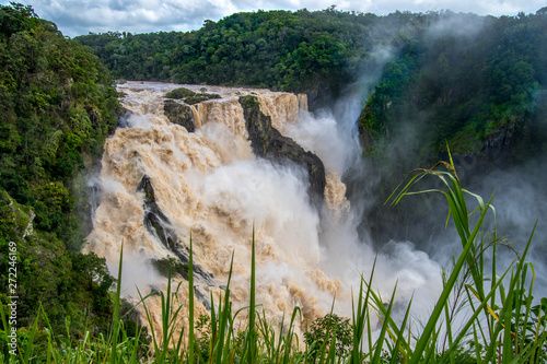 Huge tropical waterfall surrounded by rainforest on the Barron river in Queensland, Australia photo