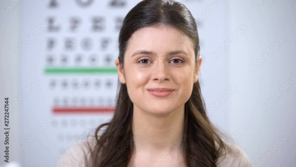 Smiling lady taking off glasses and showing case with contact lens, improvement Smiling lady taking off glasses and showing case with contact lens, improvement