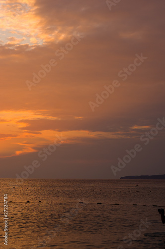 Amazing sea sunset on the pebble beach, the sun, waves, clouds © Wingedbull