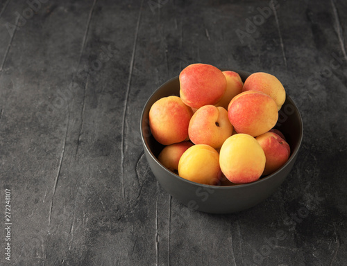 sweet delicious apricot on dark bowl grey table summer fresh fruit