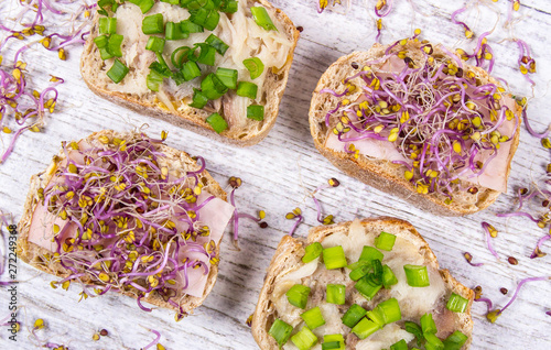 Sandwiches with ham, smoked mackerel and kale sprouts as an ingredient of a healthy diet. photo