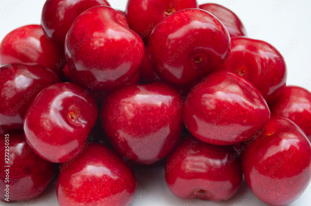 Red cherries pile macro on white background Red cherries pile macro on white background
