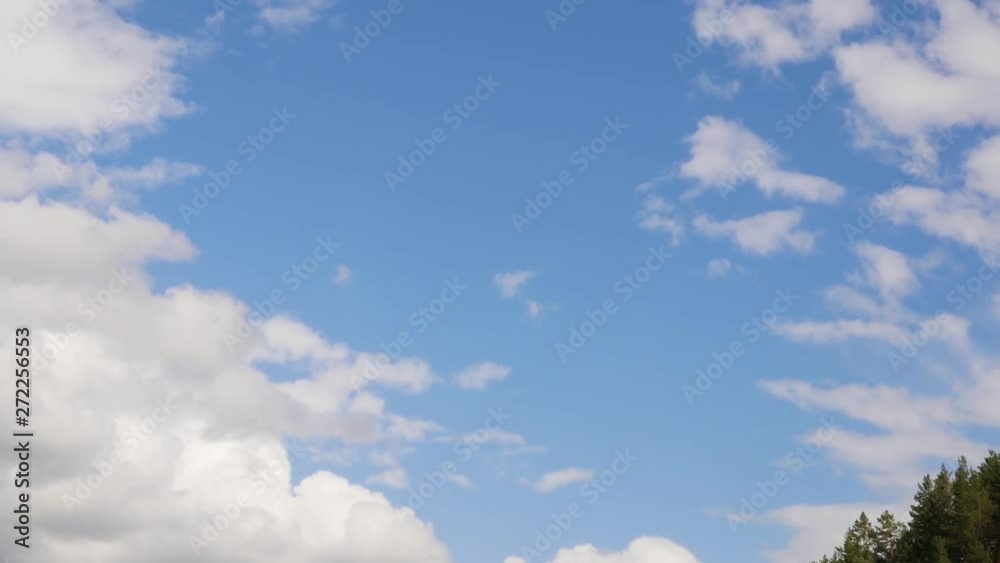 white cloud running across the blue sky, rolling puffy cloud are moving in a summer day white cloud running across the blue sky, rolling puffy cloud are moving in a summer day