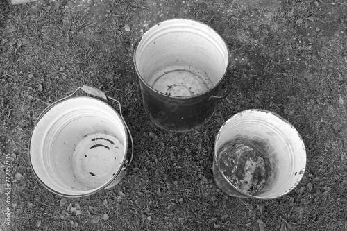 Old three buckets close-up. Monochrome.