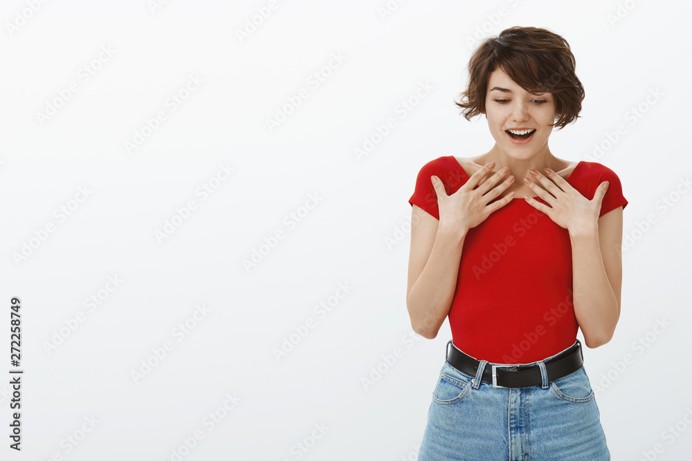 Shocked astonished excited cute young female student pixie short stylish haircut hold breath gasping touch chest stunned look down smiling broadly receive surprised awesome offer overjoy thrilled Shocked astonished excited cute young female student pixie short stylish haircut hold breath gasping touch chest stunned look down smiling broadly receive surprised awesome offer overjoy thrilled