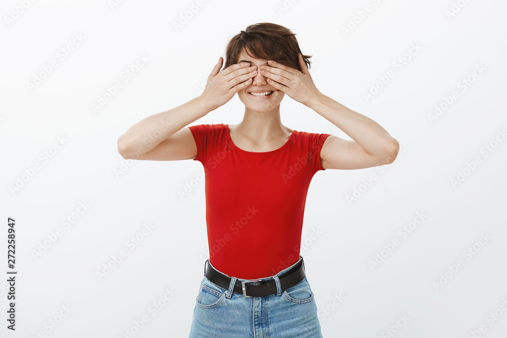 Intrigued cheerful girlfriend awaiting command open eyes hold hands face counting ten playing hide-n-seek smiling eager excited see what boyfriend prepared b-day gift stand white background Intrigued cheerful girlfriend awaiting command open eyes hold hands face counting ten playing hide-n-seek smiling eager excited see what boyfriend prepared b-day gift stand white background