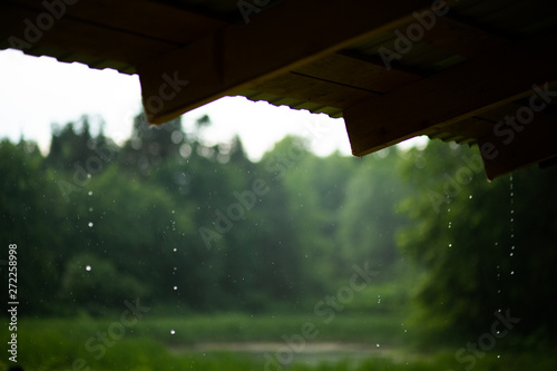 Raindrops dripping from the roof