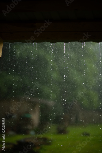 Raindrops dripping from the roof