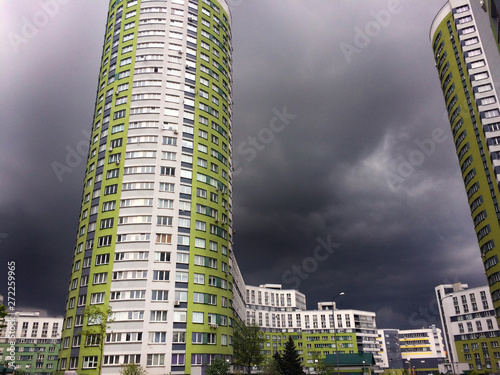 High-rise residential complex on a background of dark sky with thunderclouds