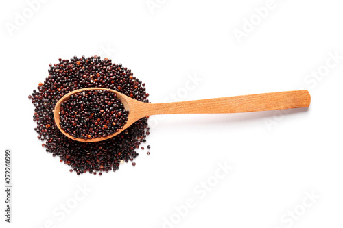 Black quinoa in a wooden spoon isolated on white background