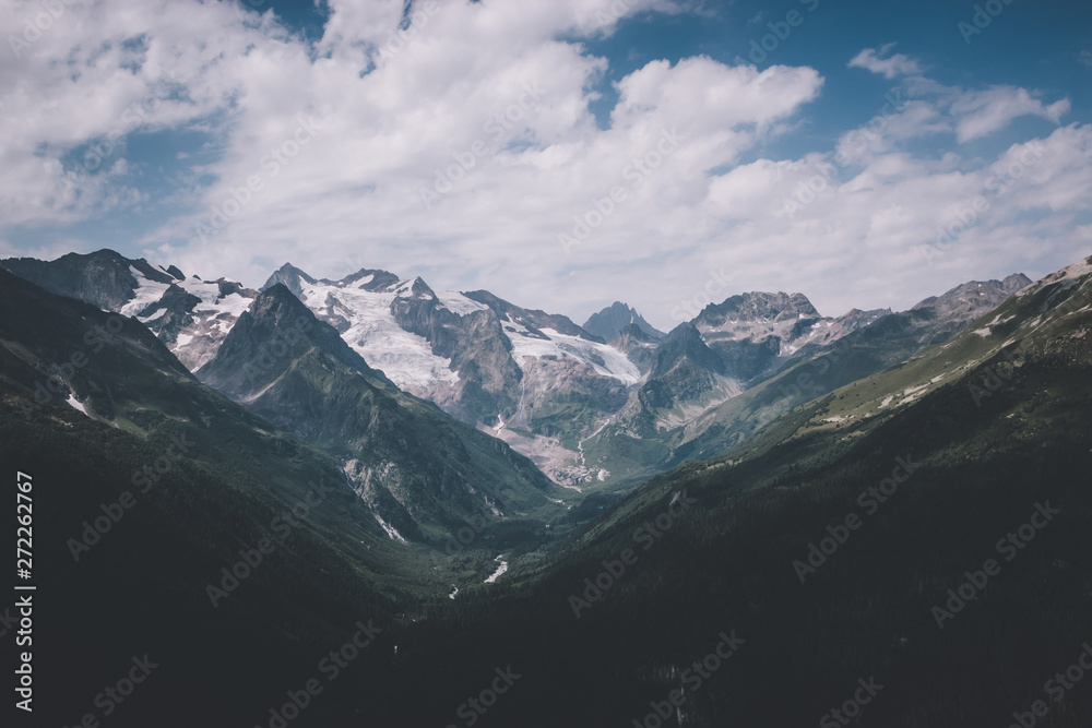 Fototapeta premium Panorama of mountains scene with dramatic blue sky in national park of Dombay