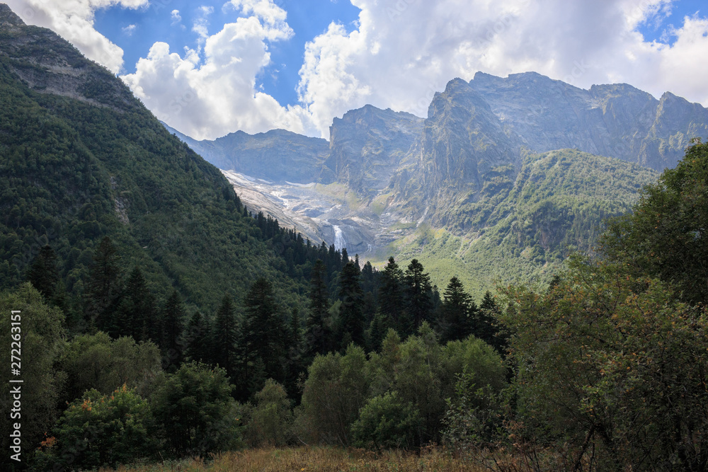 Panorama view on mountains scene and away waterfall in national park of Dombay Panorama view on mountains scene and away waterfall in national park of Dombay
