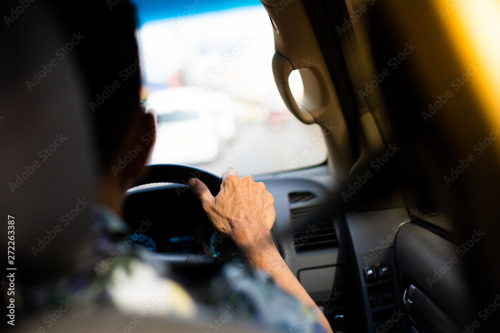 Man hands holding steering wheel in Sunny day on the road