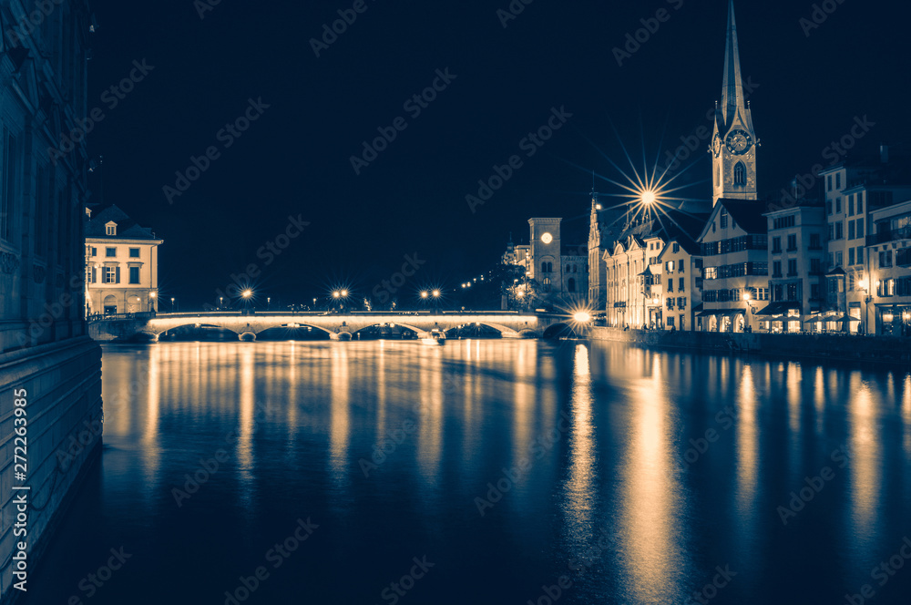 Night view of historic Zurich city center with famous Fraumunster Church Night view of historic Zurich city center with famous Fraumunster Church
