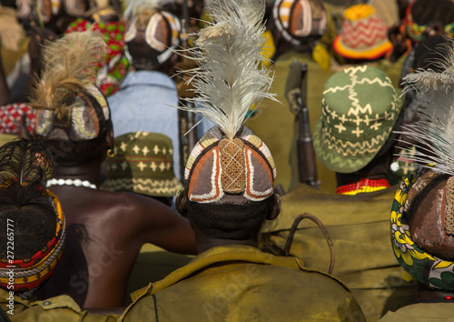 Tribe warriors during the proud ox ceremony in the dassanech tribe waiting to share the cow meat, Turkana county, Omorate, Ethiopia photo